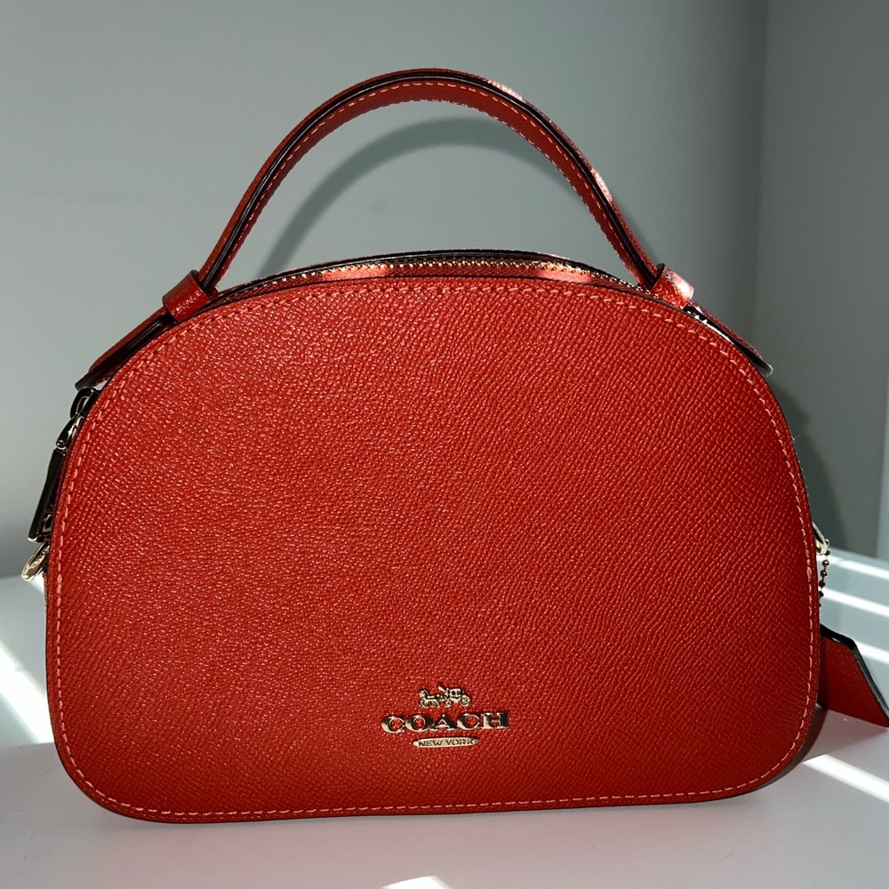 Small burnt orange leather Coach Purse with adjustable shoulder strap